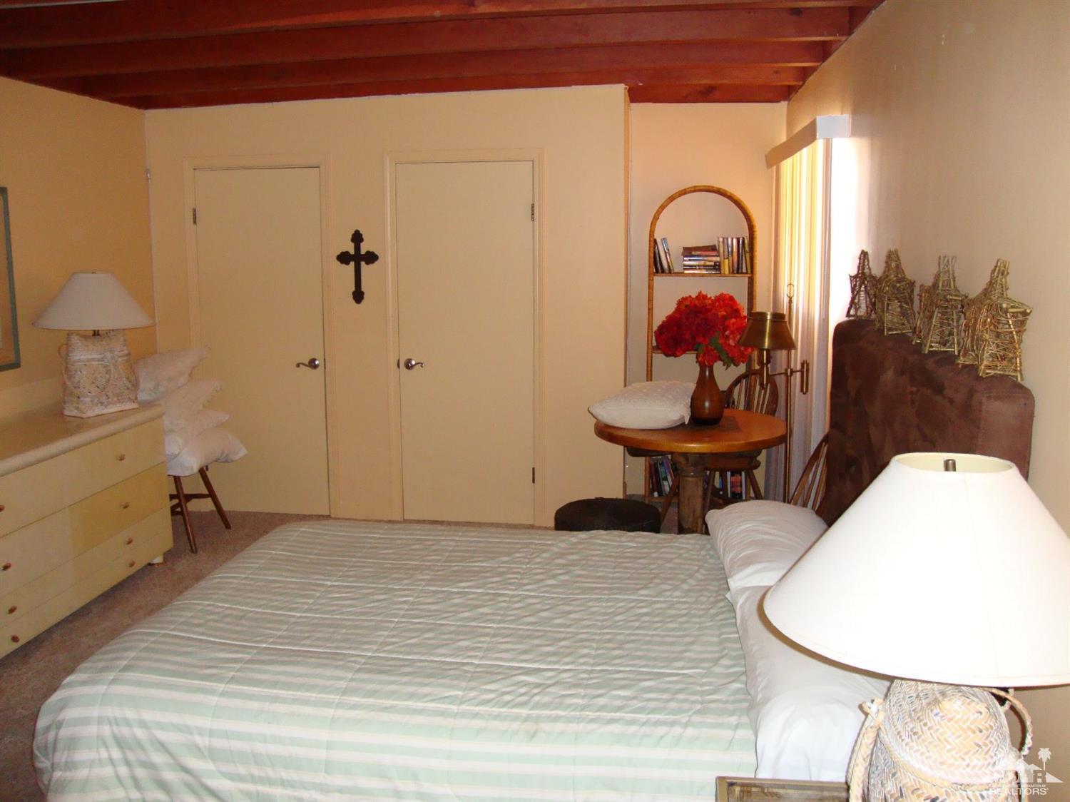 66671 San Rafael Road Desert Hot Springs, CA 92240 - Photo 25 of 36 a bed room with a bed and a chair