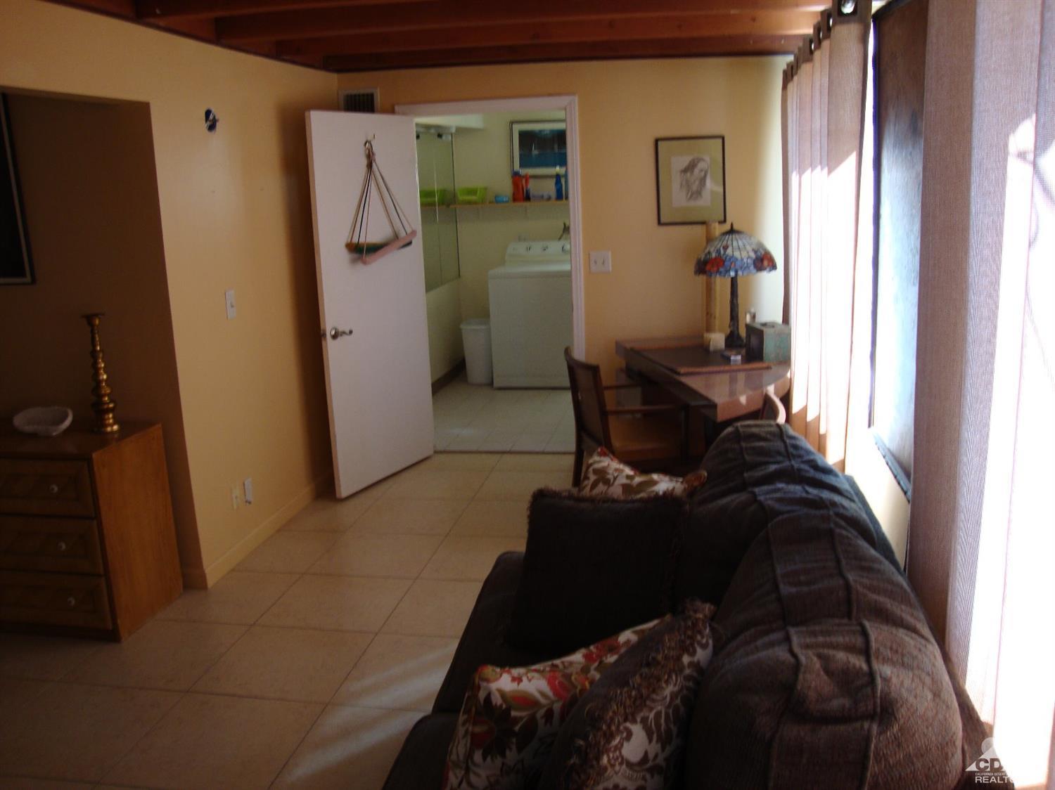 66671 San Rafael Road Desert Hot Springs, CA 92240 - Photo 26 of 36 a living room with furniture and a window