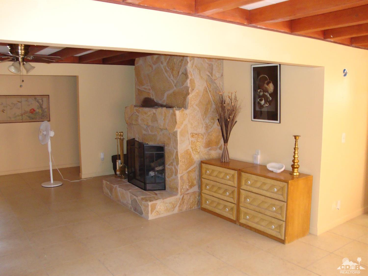 66671 San Rafael Road Desert Hot Springs, CA 92240 - Photo 27 of 36 a view of an empty room with fireplace and a window