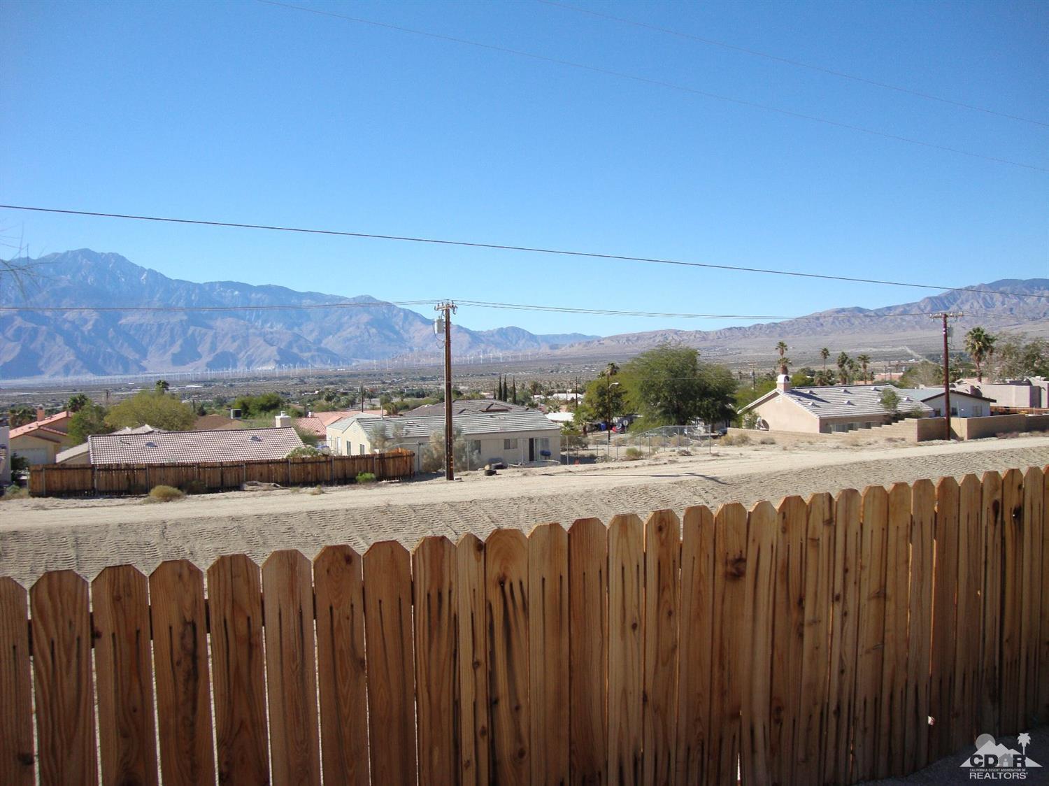66671 San Rafael Road Desert Hot Springs, CA 92240 - Photo 33 of 36 a view of a yard with wooden fence