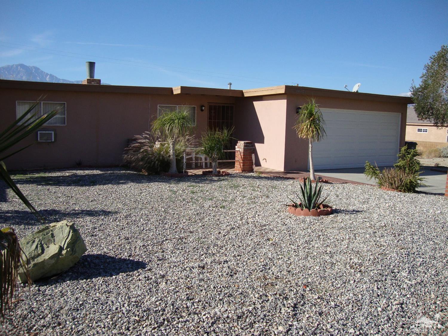 66671 San Rafael Road Desert Hot Springs, CA 92240 - Photo 5 of 36 a front view of a house with garden