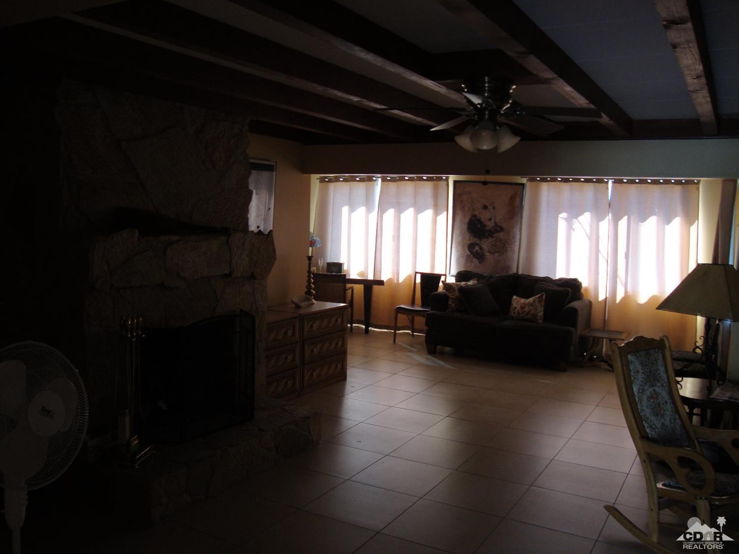 66671 San Rafael Road Desert Hot Springs, CA 92240 - Photo 7 of 36 a living room with furniture and a large window