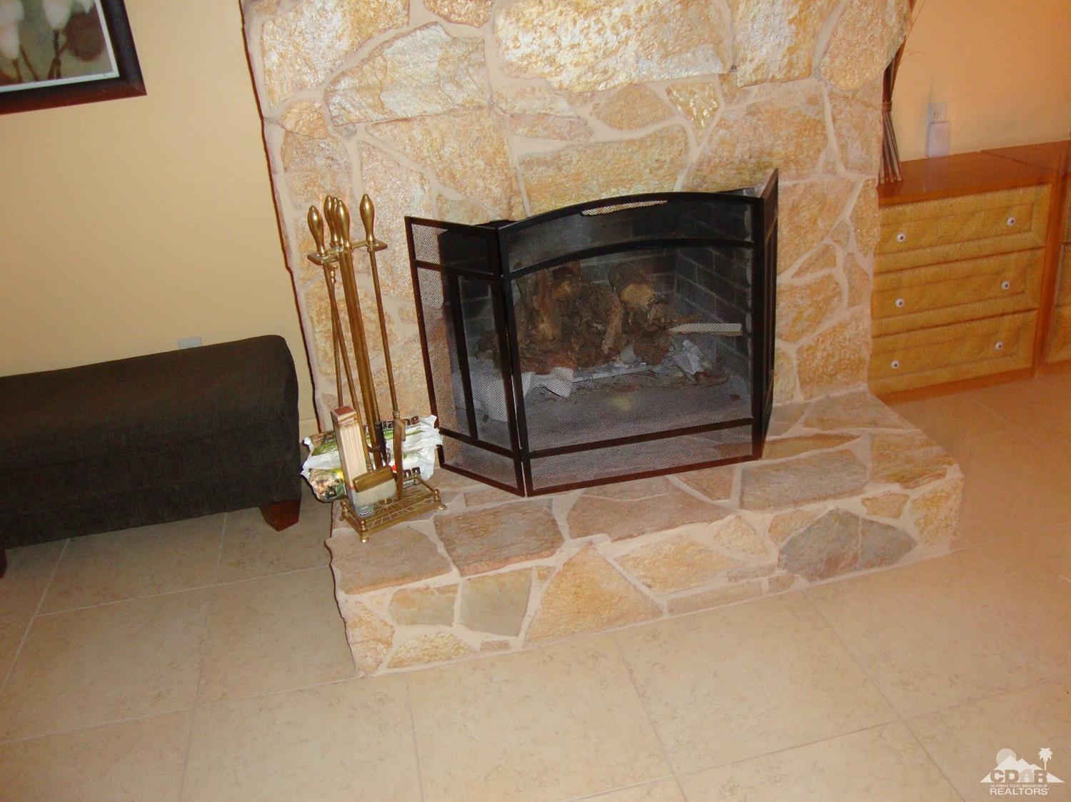 66671 San Rafael Road Desert Hot Springs, CA 92240 - Photo 8 of 36 a living room with a fireplace