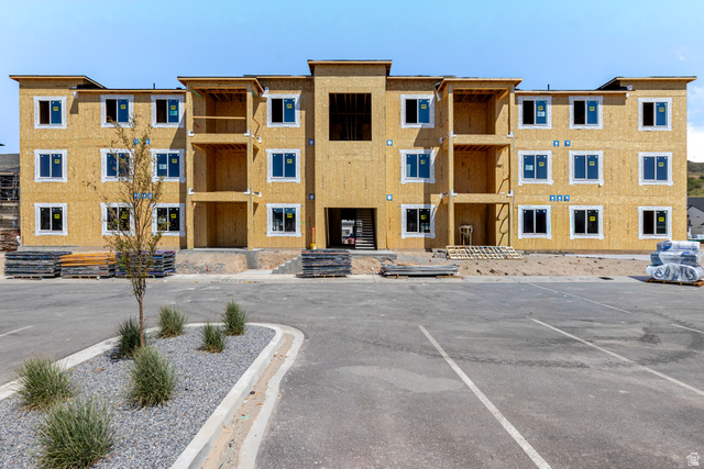 4727 South 690th West, Unit W302 Mapleton, UT 84664 - Photo 1 of 4 Multi-story structure featuring a wood sheathing exterior, numerous uniformly sized windows, and integrated balconies