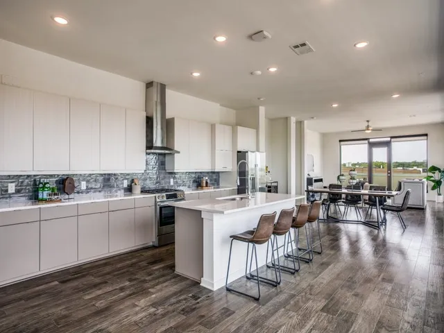 a kitchen with lots of counter top space and furniture