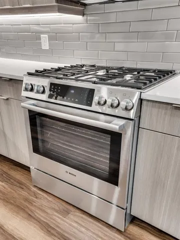 a stove top oven sitting inside of a kitchen