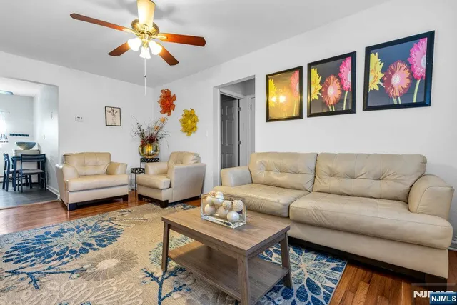 a living room with furniture ceiling fan and a rug