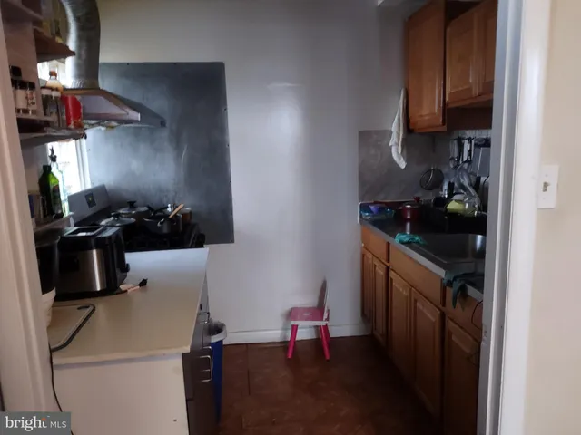 a kitchen with a sink stove and refrigerator