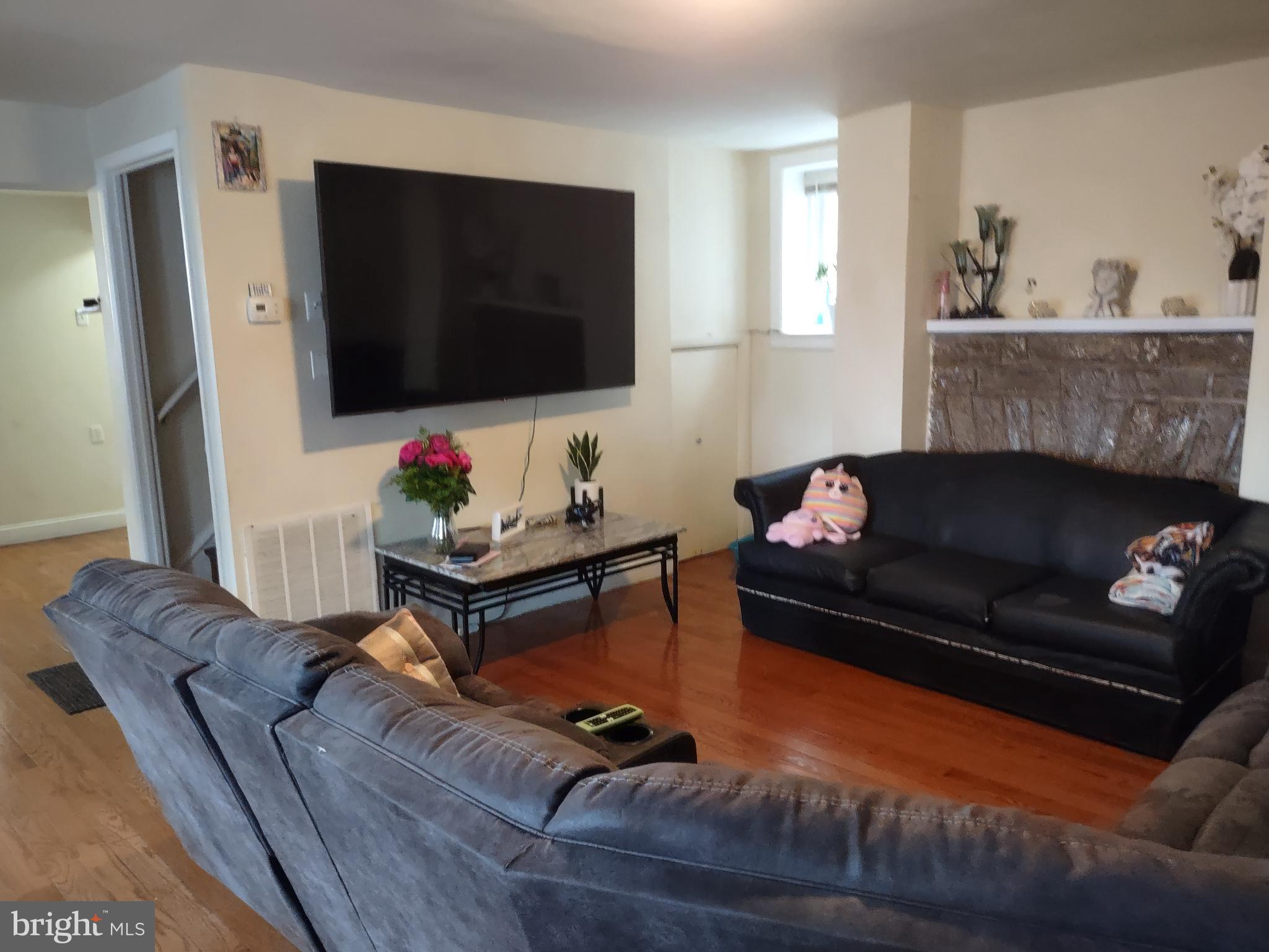 101 Copley Road Upper Darby, PA 19082 - Photo 15 of 36 a living room with furniture and a flat screen tv