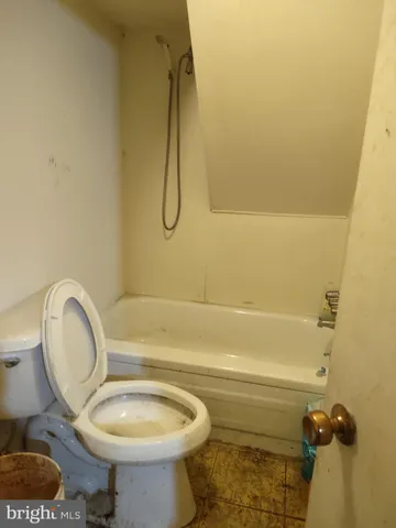 a bathroom with a sink mirror vanity and toilet