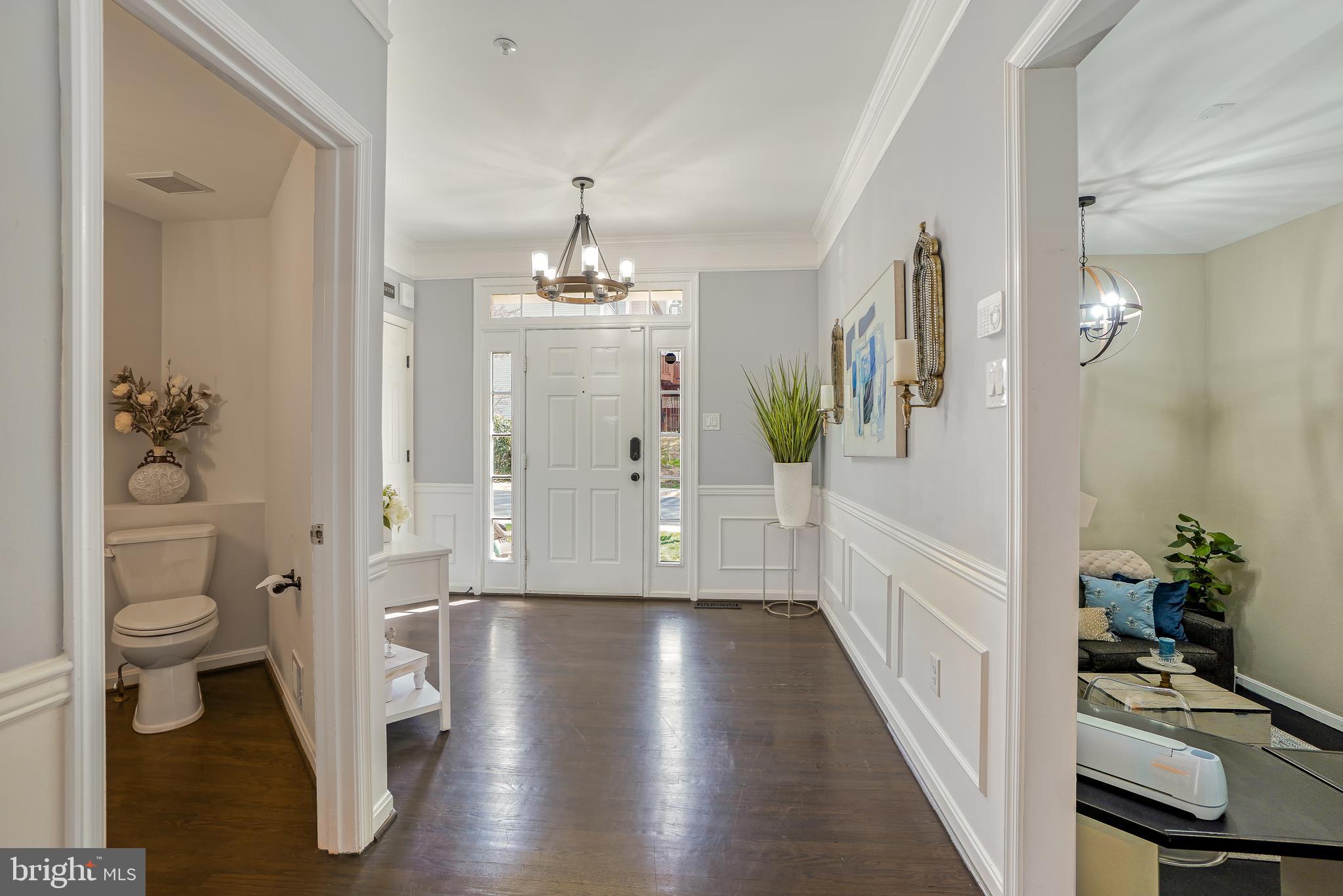 17963 Dumfries Circle Olney, MD 20832 - Photo 13 of 42 a view of a hallway view with wooden floor and dining room