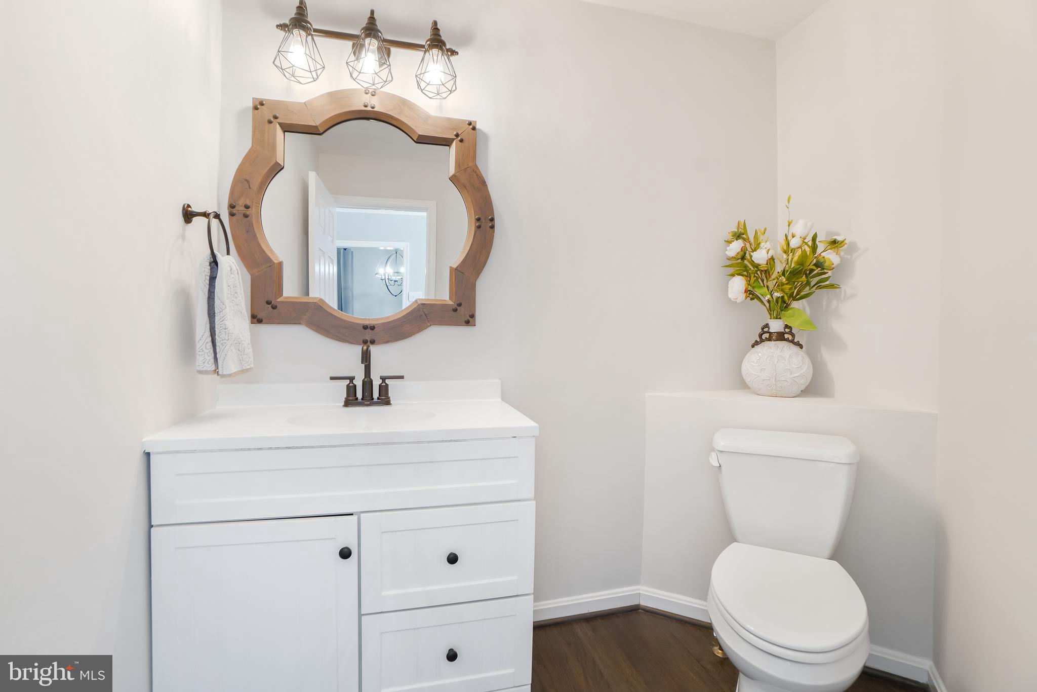 17963 Dumfries Circle Olney, MD 20832 - Photo 16 of 42 a bathroom with a toilet sink and mirror