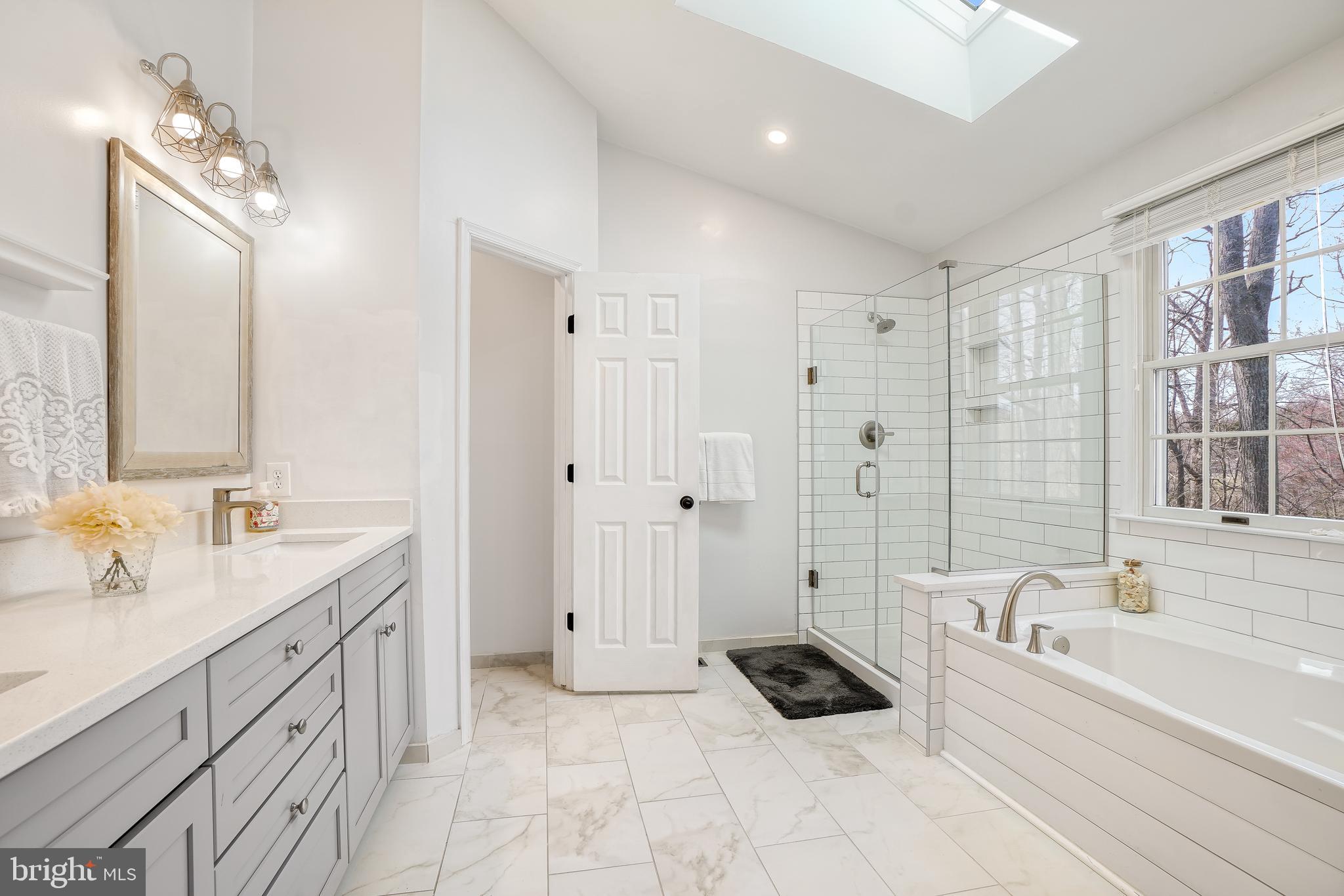 17963 Dumfries Circle Olney, MD 20832 - Photo 19 of 42 a bathroom with a tub sink and mirror