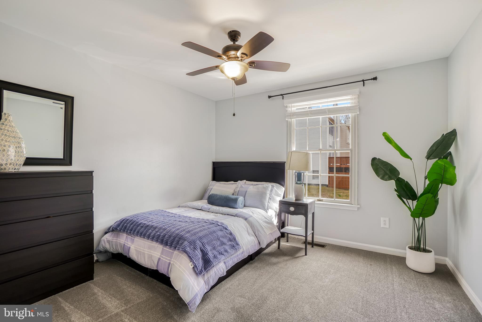 17963 Dumfries Circle Olney, MD 20832 - Photo 25 of 42 a bedroom with a bed and a chandelier