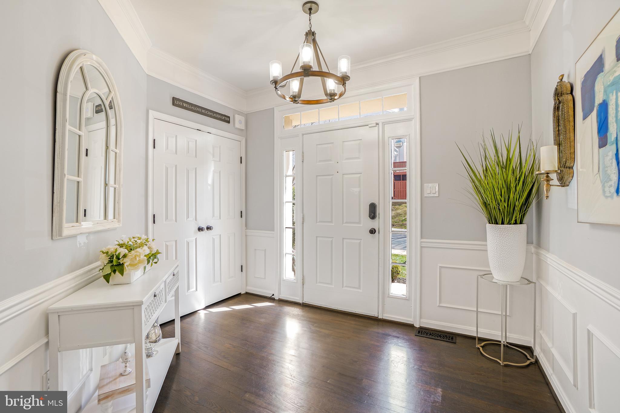 17963 Dumfries Circle Olney, MD 20832 - Photo 3 of 42 a hallway with wooden floor and windows