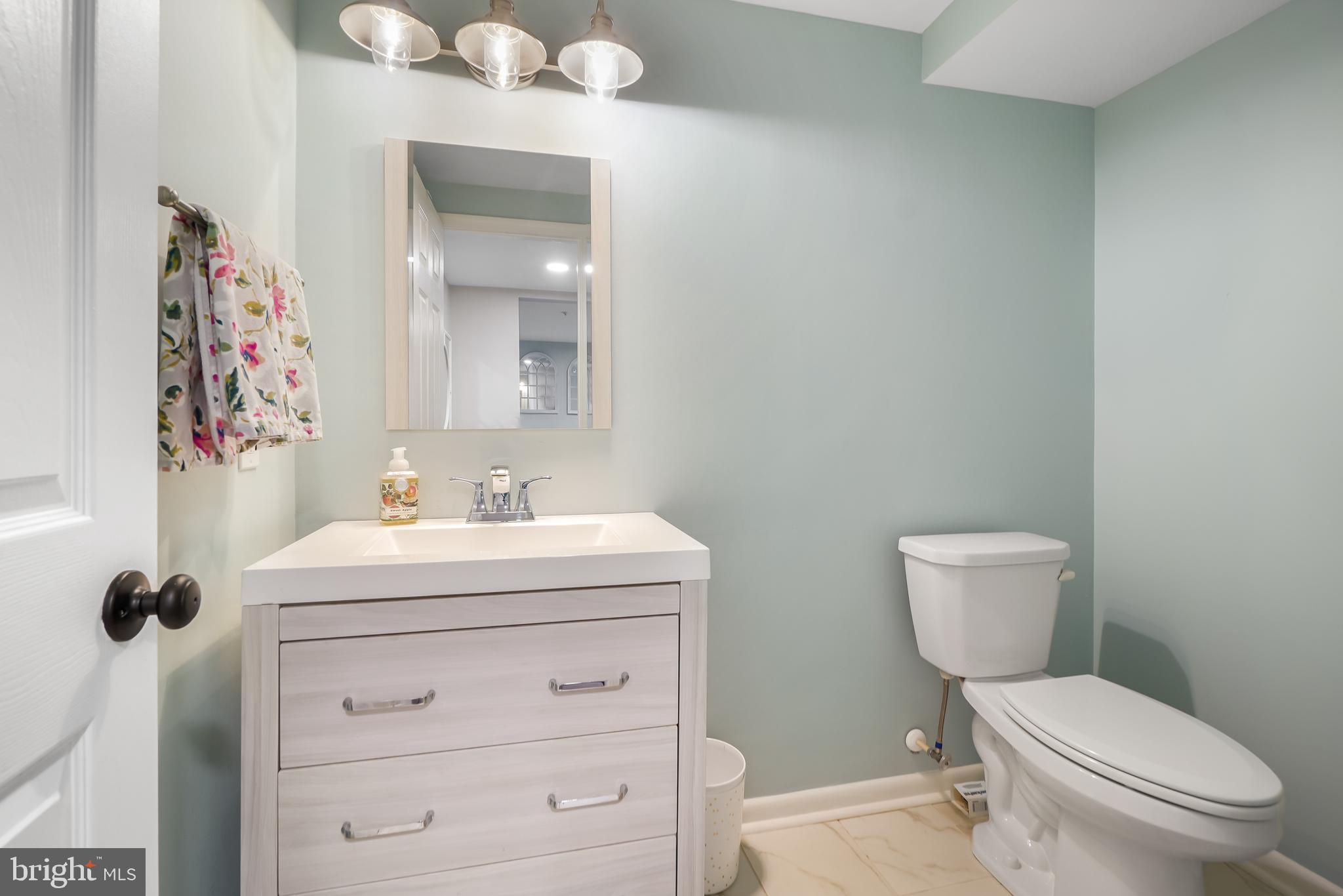 17963 Dumfries Circle Olney, MD 20832 - Photo 31 of 42 a bathroom with a toilet a sink and mirror