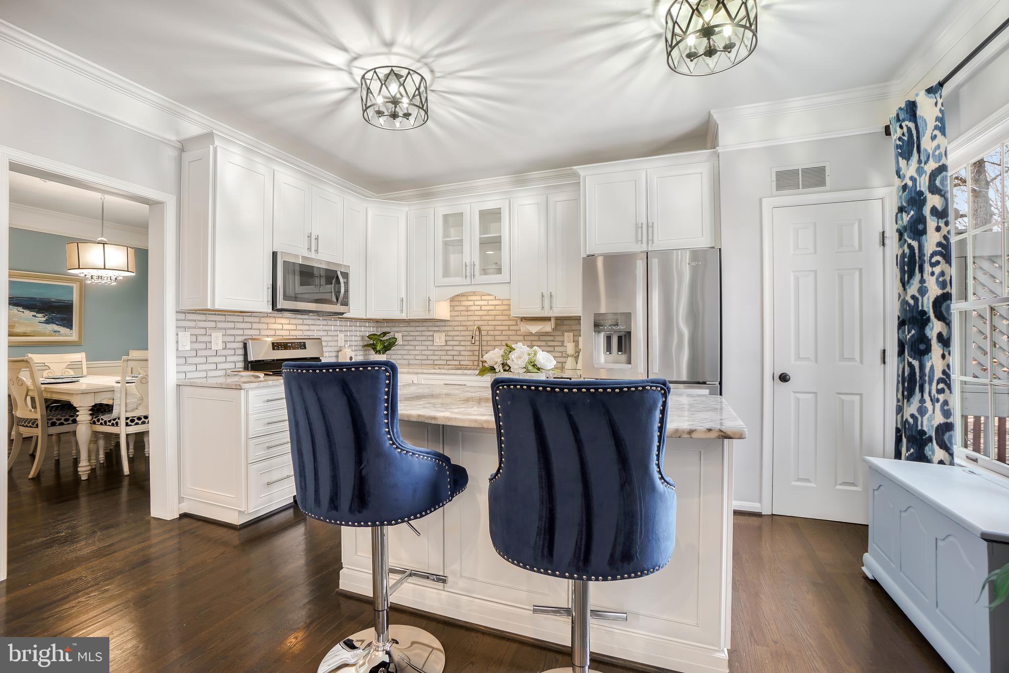 17963 Dumfries Circle Olney, MD 20832 - Photo 5 of 42 a kitchen with stainless steel appliances a dining table chairs and chandelier