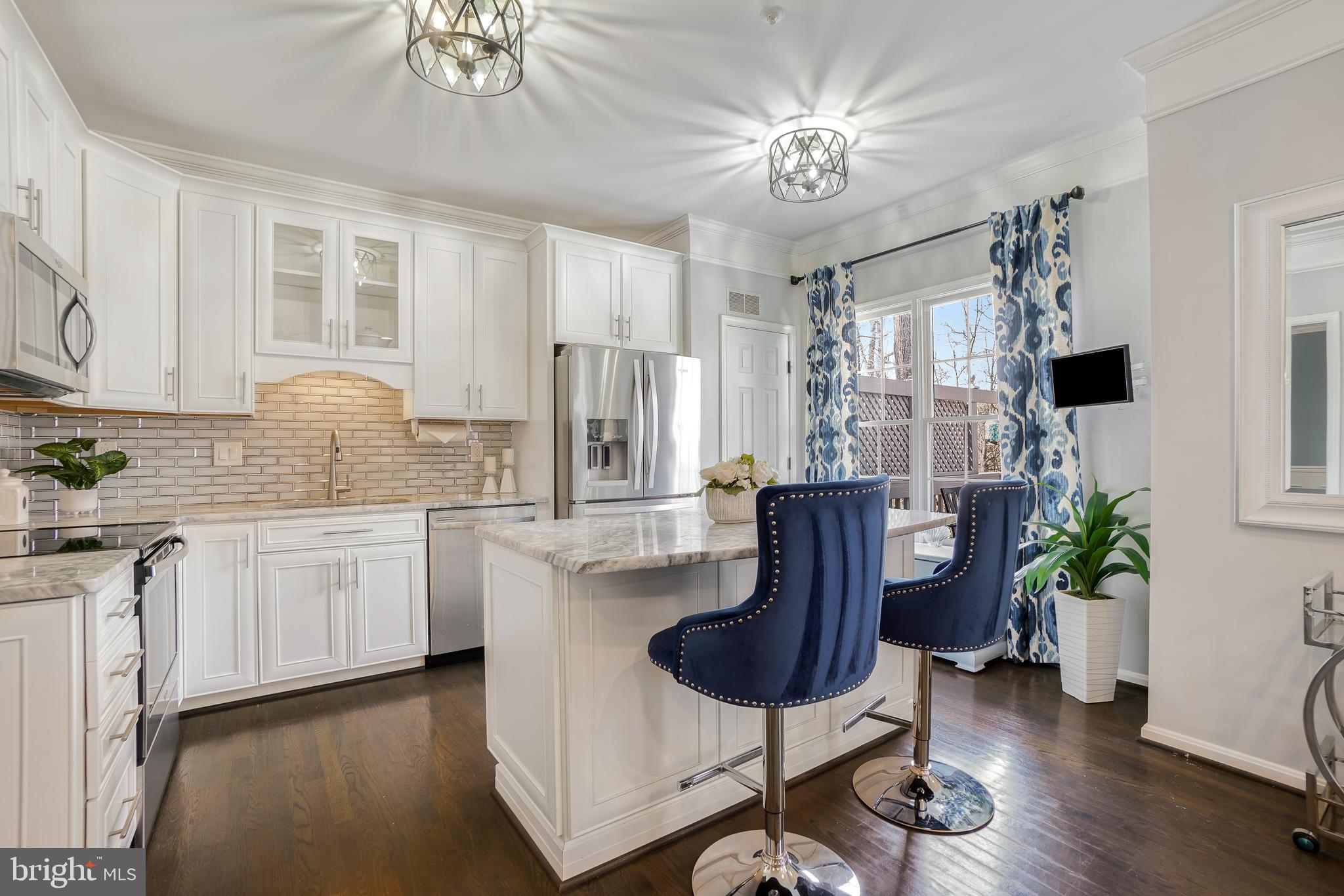 17963 Dumfries Circle Olney, MD 20832 - Photo 6 of 42 a kitchen with stainless steel appliances granite countertop a refrigerator a stove a sink dishwasher and white cabinets with wooden floor