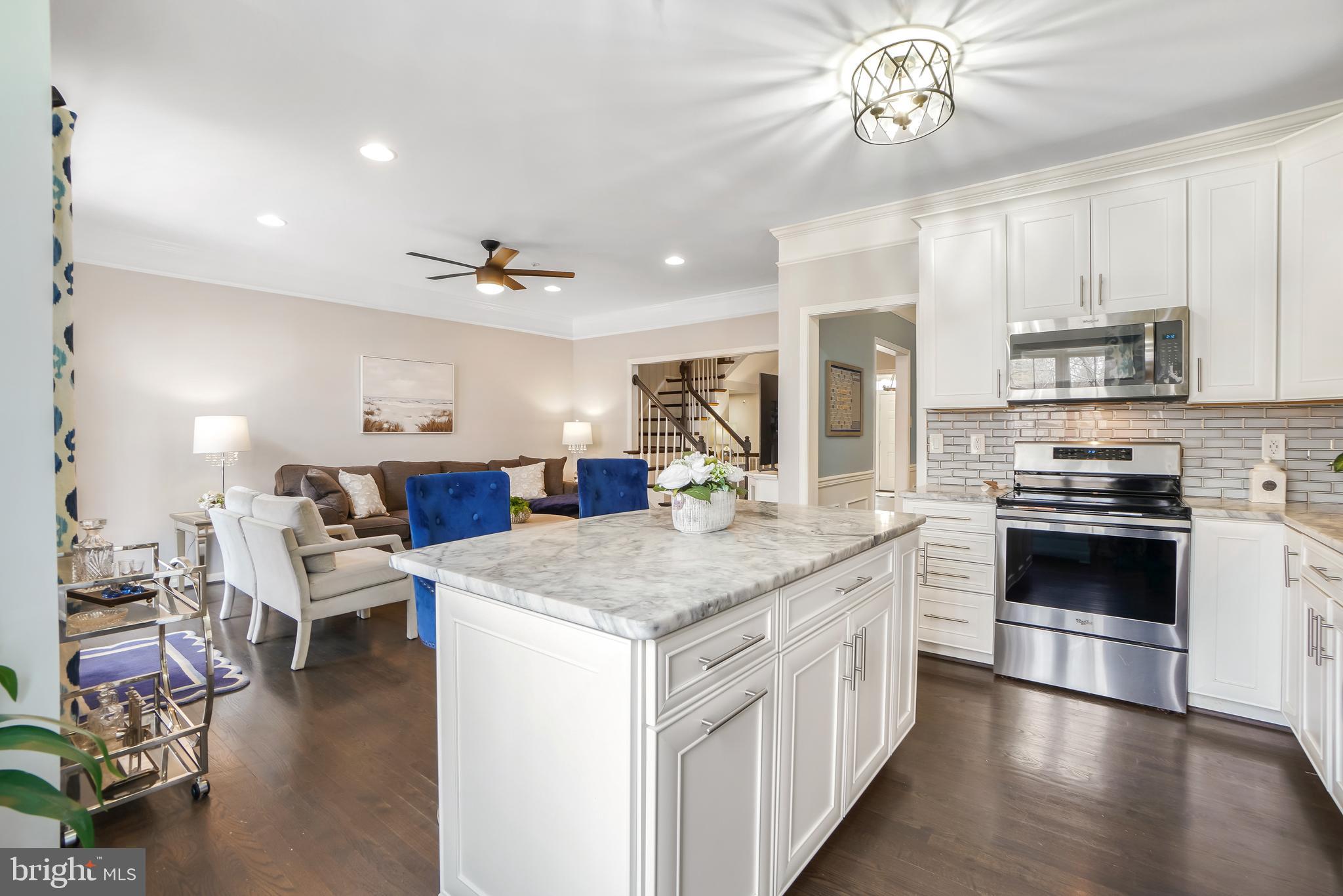 17963 Dumfries Circle Olney, MD 20832 - Photo 8 of 42 a kitchen with stainless steel appliances granite countertop a stove oven and a refrigerator with white cabinets