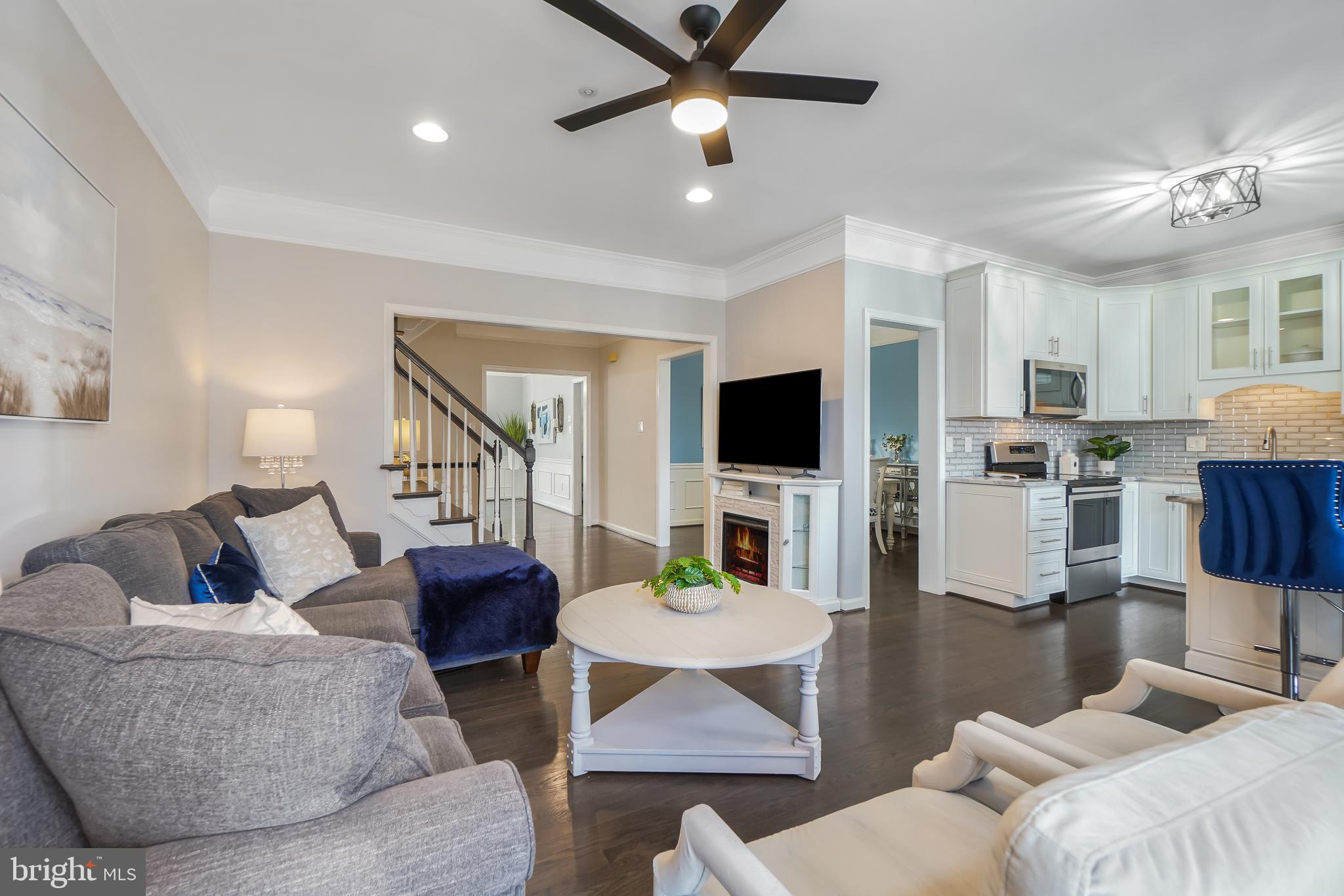 17963 Dumfries Circle Olney, MD 20832 - Photo 9 of 42 a living room with furniture a flat screen tv and kitchen view