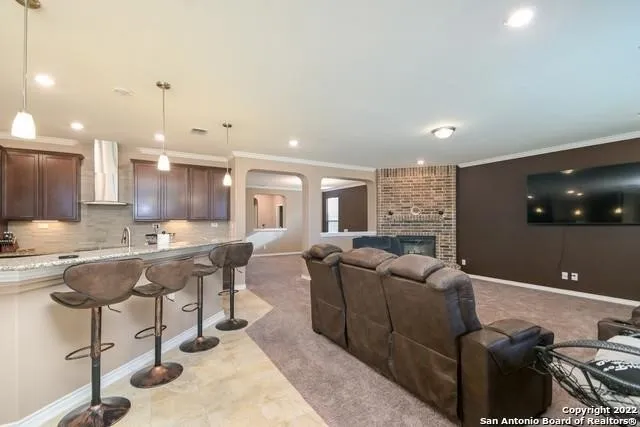 a living room with furniture and a dining table with kitchen view