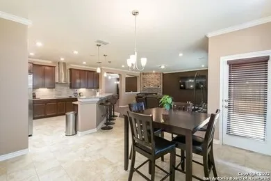 a view of a dining room and chandelier furniture and kitchen view