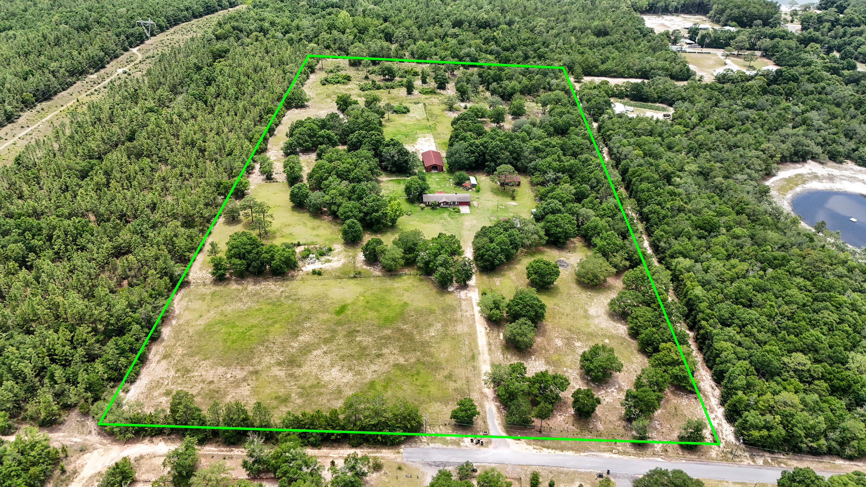 an aerial view of a residential houses with yard