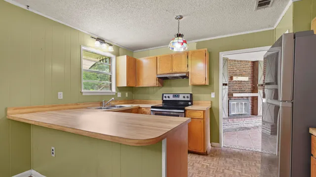 a utility room with a sink cabinets and a window