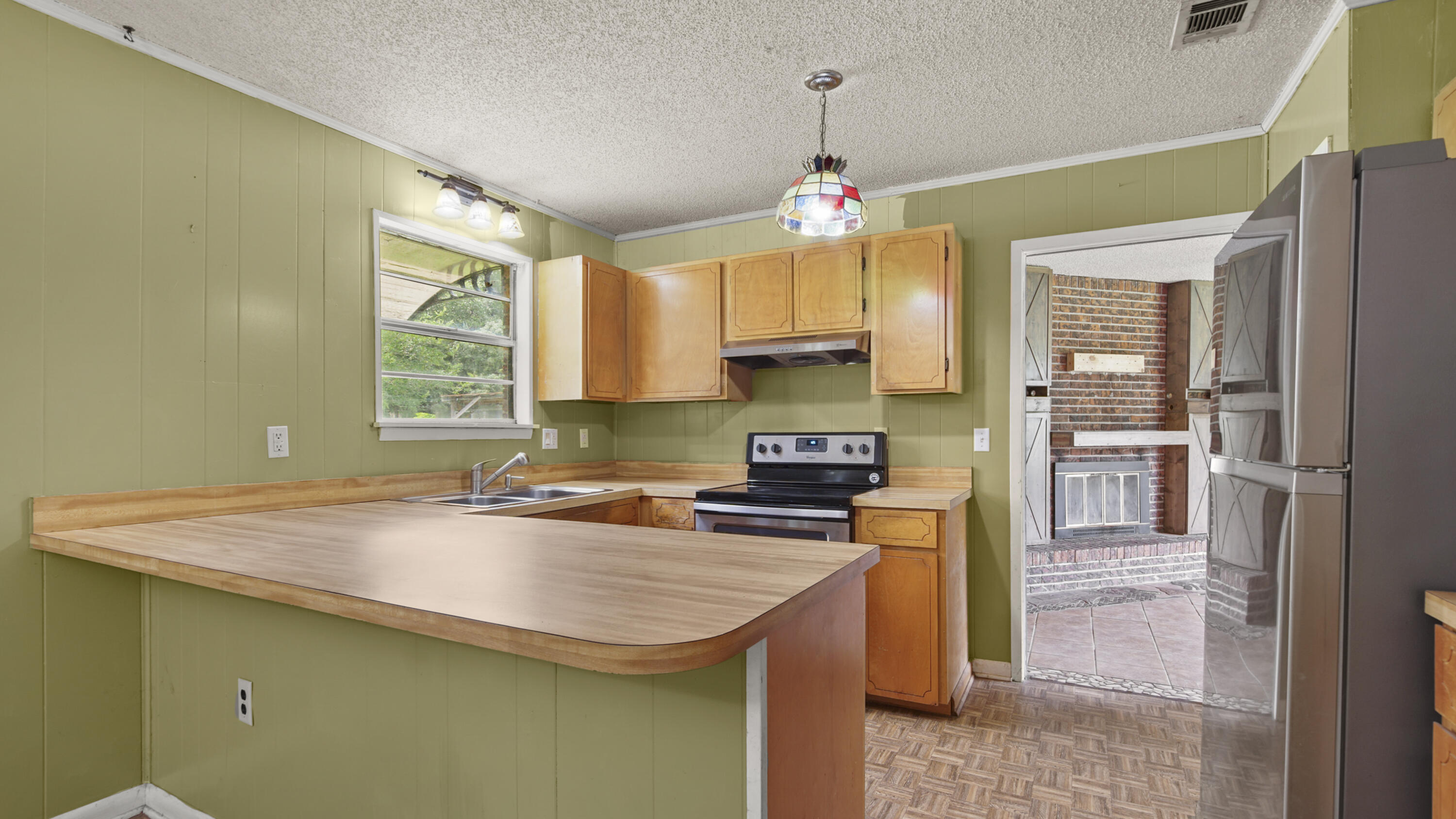 270 Windham Way DeFuniak Springs, FL 32433 - Photo 15 of 51 a kitchen with stainless steel appliances a sink stove and refrigerator