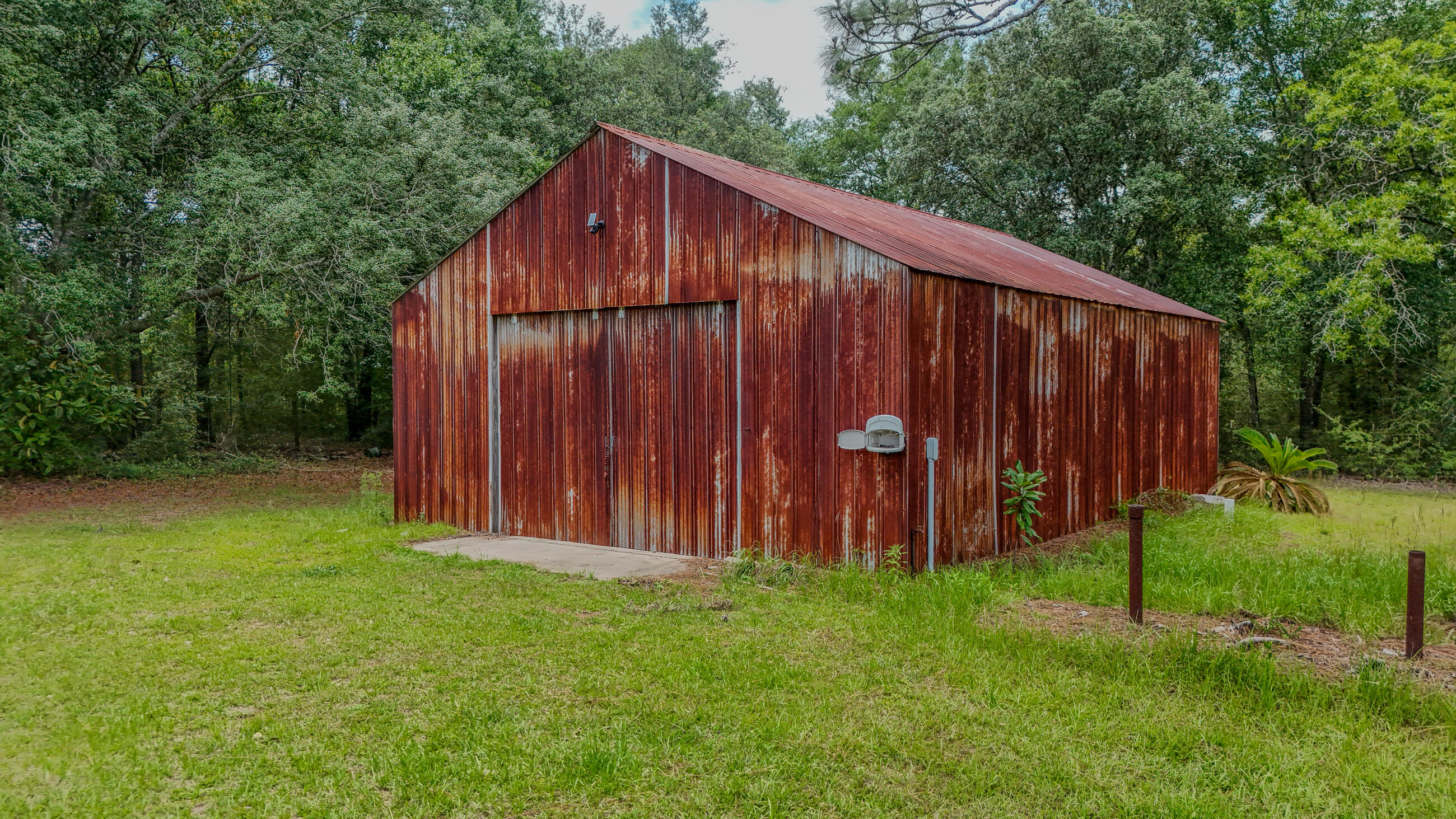 270 Windham Way DeFuniak Springs, FL 32433 - Photo 41 of 51 a view of a backyard with wooden fence and a cabin
