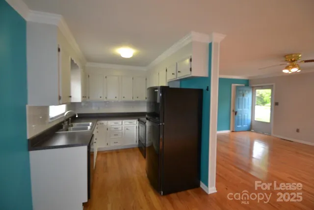 a kitchen with a refrigerator and a counter top space