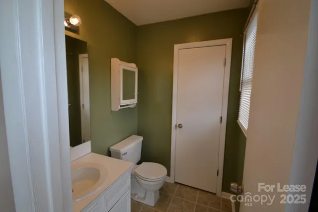 a white toilet sitting next to a bathroom sink