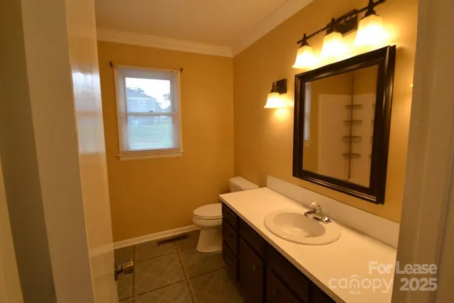 a bathroom with a sink toilet and mirror