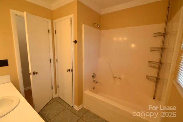a bathroom with a shower and a glass door
