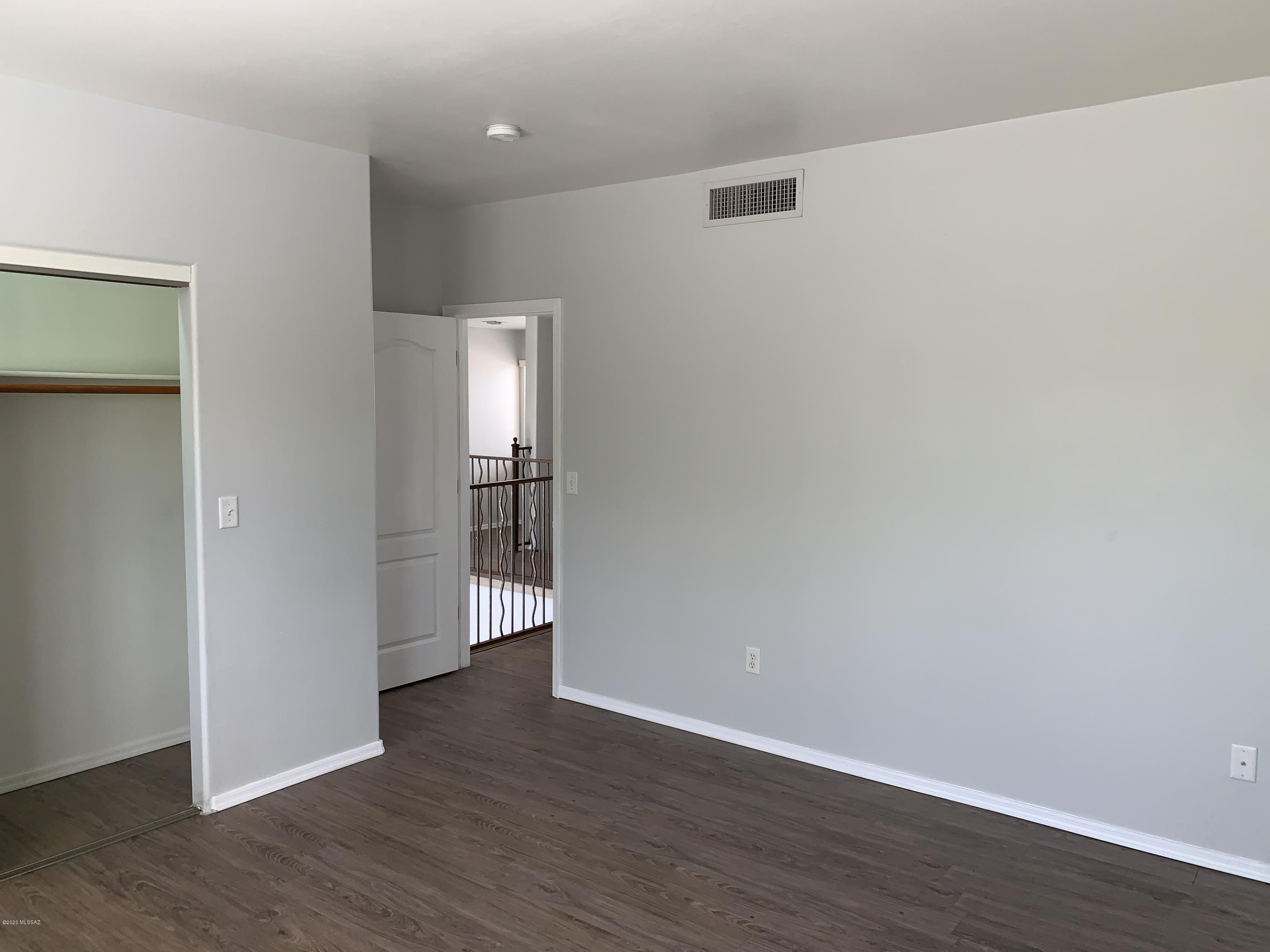 4181 North Fortune Loop Tucson, AZ 85719 - Photo 28 of 39 an empty room with wooden floor & windows