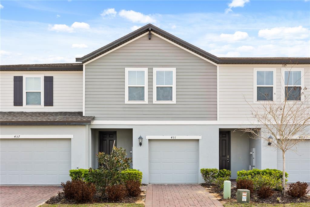 431 Legacy Loop Davenport, FL 33896 - Photo 1 of 25 a front view of a house with plants