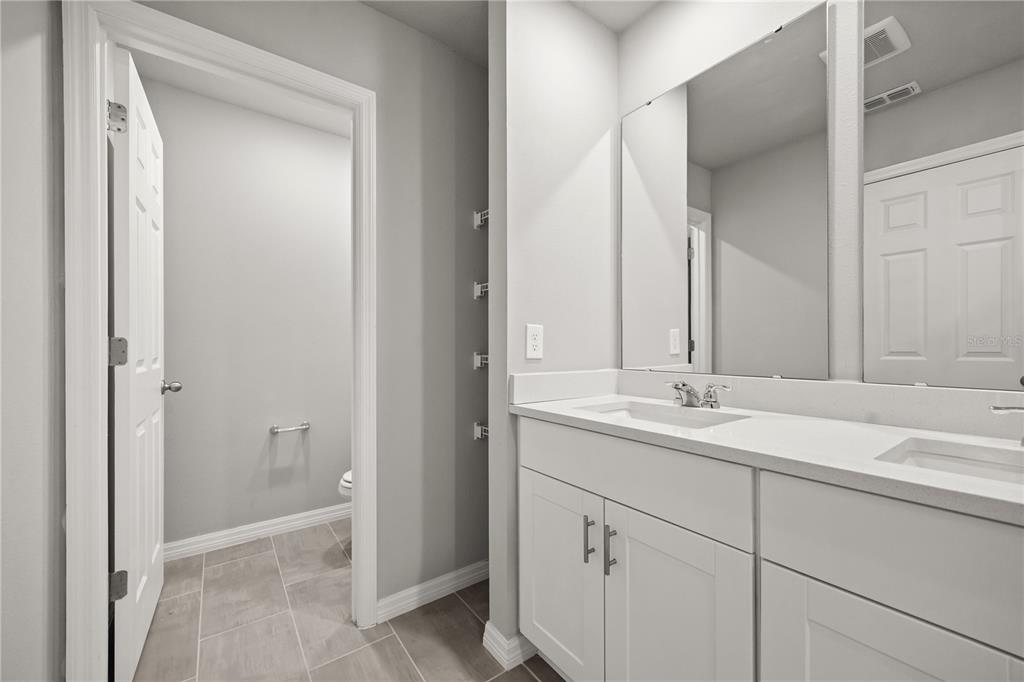 431 Legacy Loop Davenport, FL 33896 - Photo 12 of 25 a bathroom with a sink and a mirror