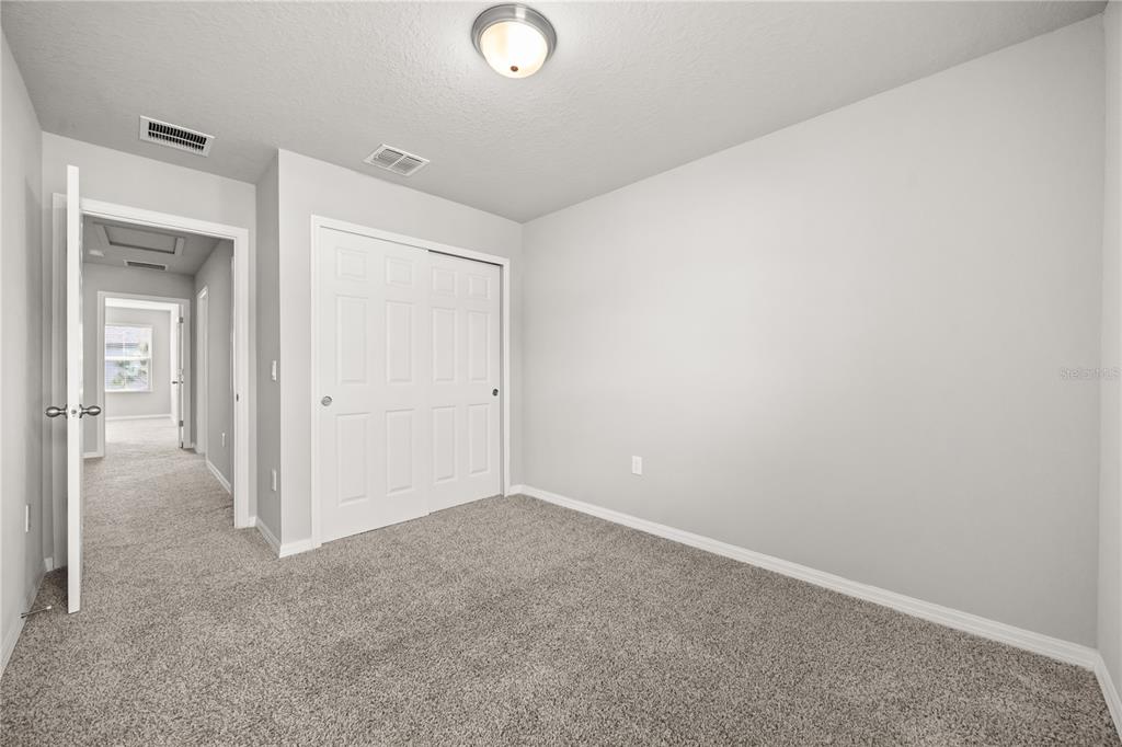 431 Legacy Loop Davenport, FL 33896 - Photo 18 of 25 an empty room with closet area