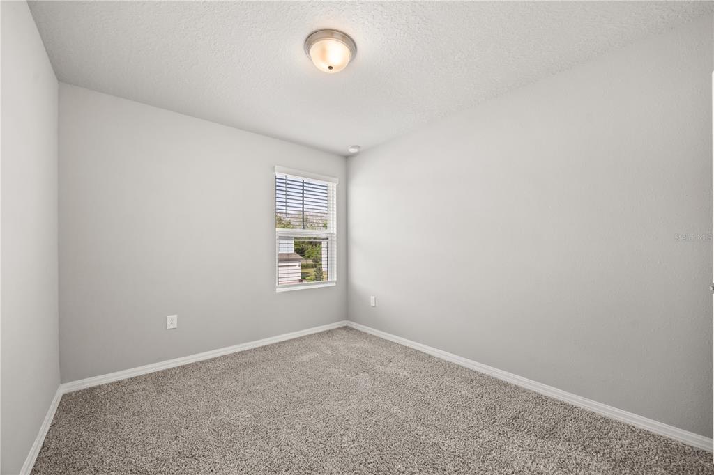 431 Legacy Loop Davenport, FL 33896 - Photo 19 of 25 an empty room with a window