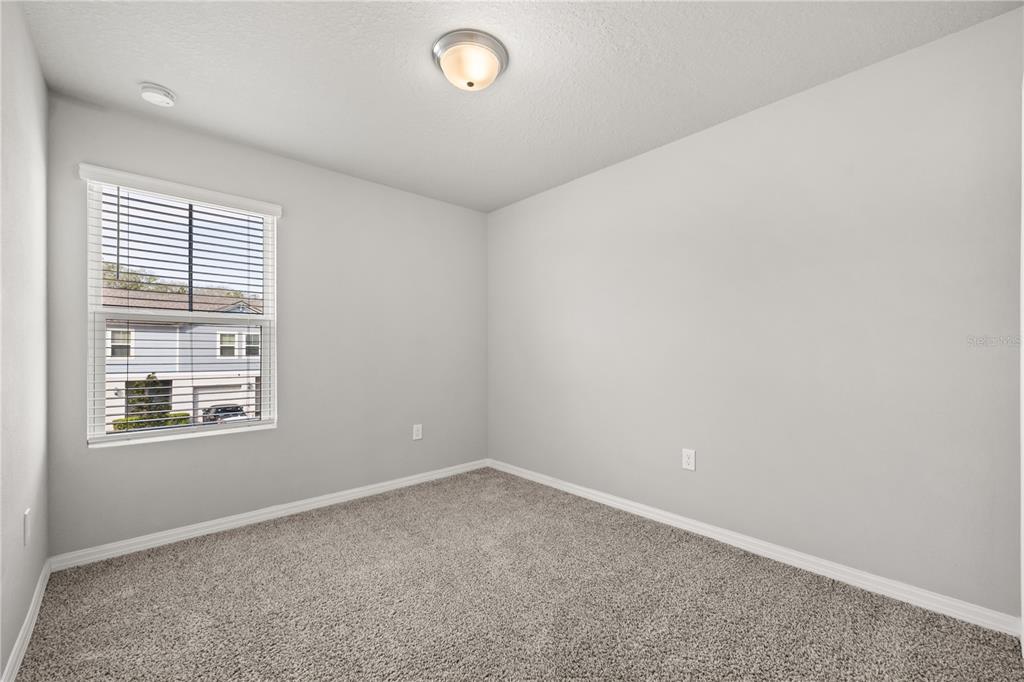 431 Legacy Loop Davenport, FL 33896 - Photo 20 of 25 an empty room with a window