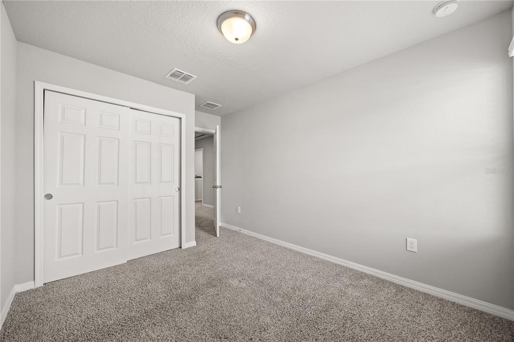 431 Legacy Loop Davenport, FL 33896 - Photo 21 of 25 an empty room with closet area