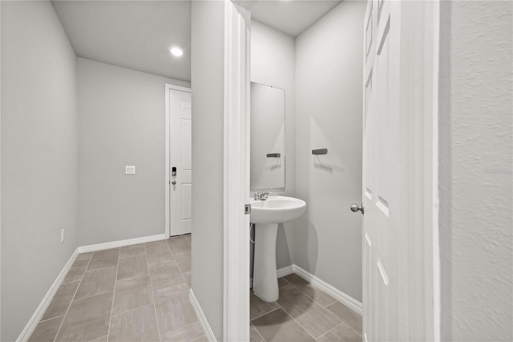 431 Legacy Loop Davenport, FL 33896 - Photo 22 of 25 a bathroom with a sink and a toilet