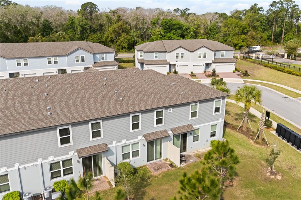 431 Legacy Loop Davenport, FL 33896 - Photo 24 of 25 a view of a big house with a big yard and large trees