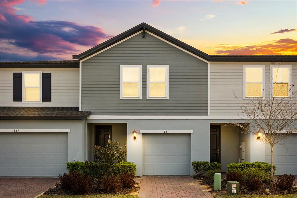 431 Legacy Loop Davenport, FL 33896 - Photo 25 of 25 a front view of a house with yellow lighting