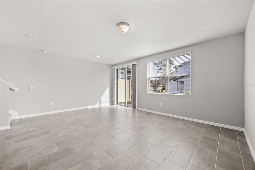 431 Legacy Loop Davenport, FL 33896 - Photo 5 of 25 a view of an empty room with a window