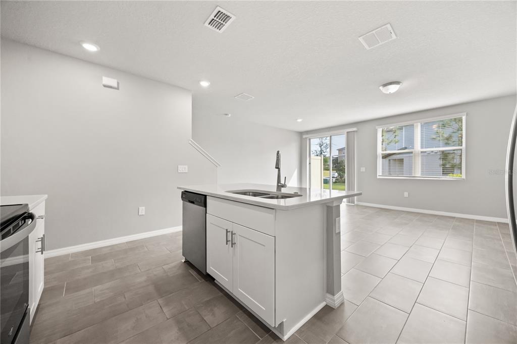 431 Legacy Loop Davenport, FL 33896 - Photo 8 of 25 a kitchen with granite countertop a sink and cabinets