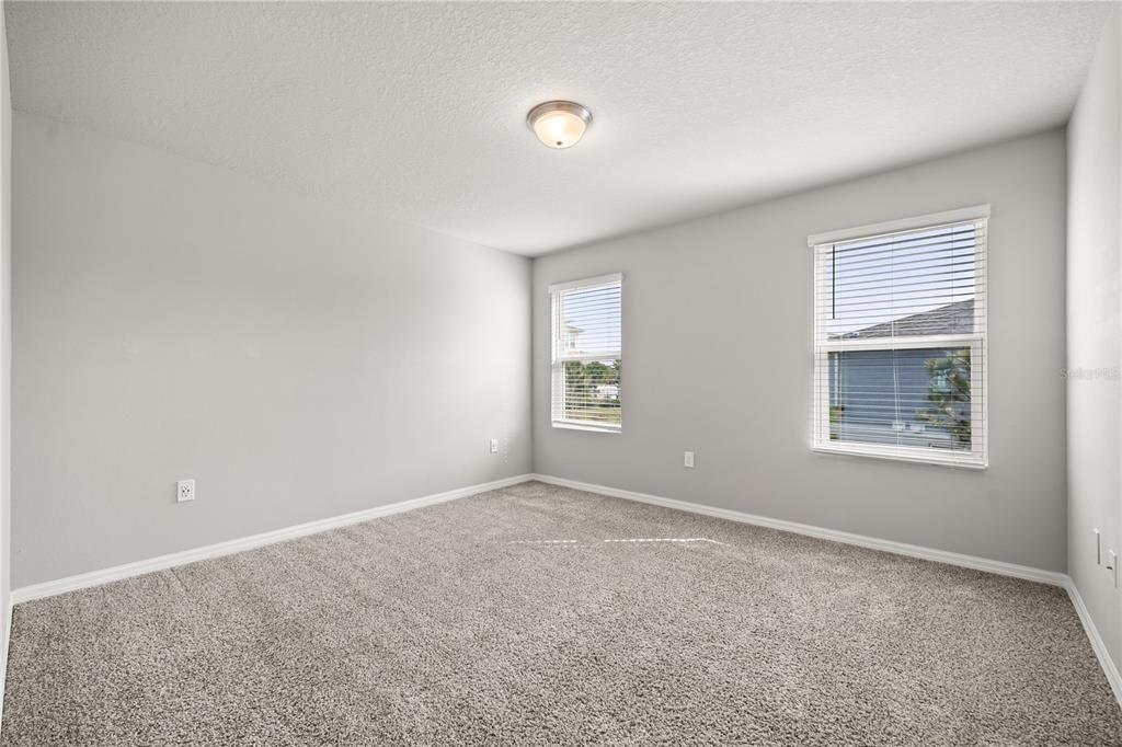 431 Legacy Loop Davenport, FL 33896 - Photo 9 of 25 a view of an empty room with closet and a window