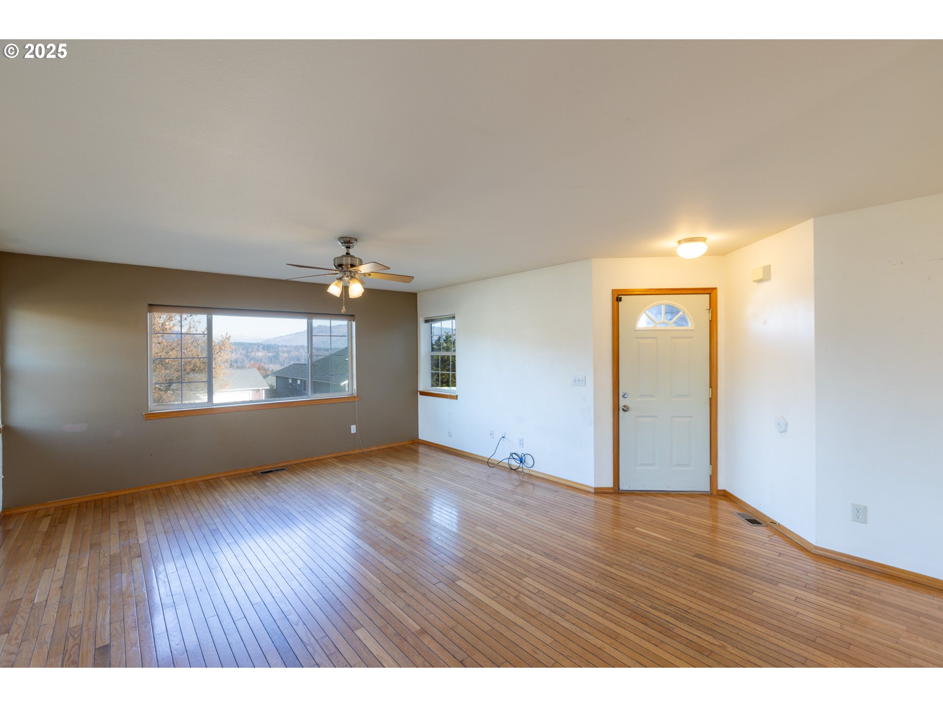 2957 Eugene Street Hood River, OR 97031 - Photo 22 of 42 a view of an empty room with wooden floor and a window