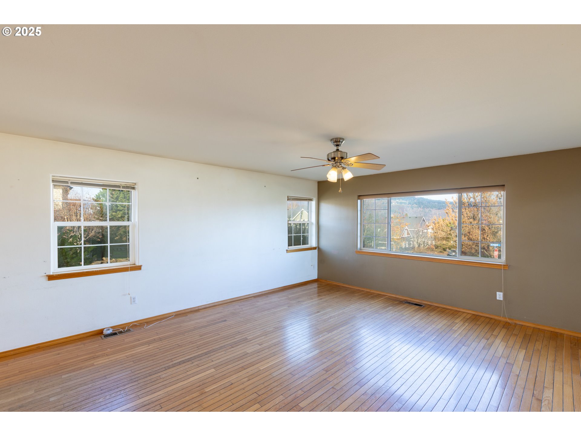 2957 Eugene Street Hood River, OR 97031 - Photo 23 of 42 an empty room with wooden floor and windows
