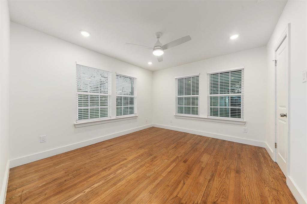715 Dover Street Dallas, TX 75216 - Photo 6 of 8 Spacious room featuring wood-finish flooring, white walls, multiple windows with blinds, a ceiling fan, and recessed lighting
